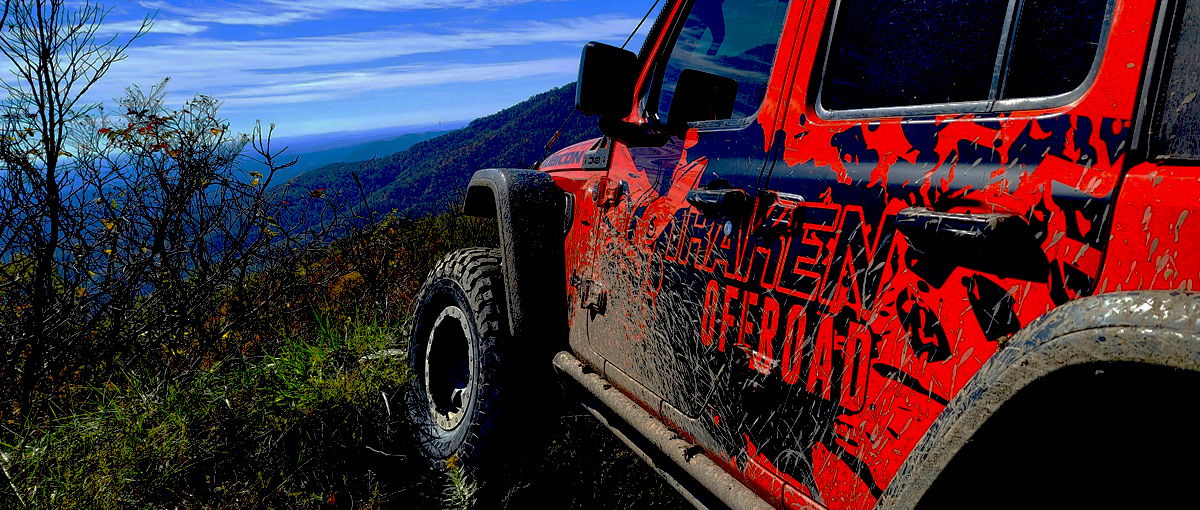 Orange and Black Jeep Wrangler on a Rocky Mountain Trail